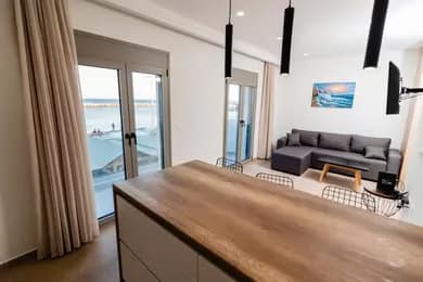 Photo from Chrysoulas Apartment kitchen counter and living room.avif